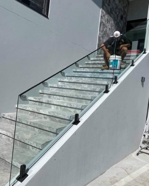 Man painting Stairs - Glass & Glazing in Cannonvale, QLD